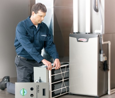 Man replacing a filter on a furnace